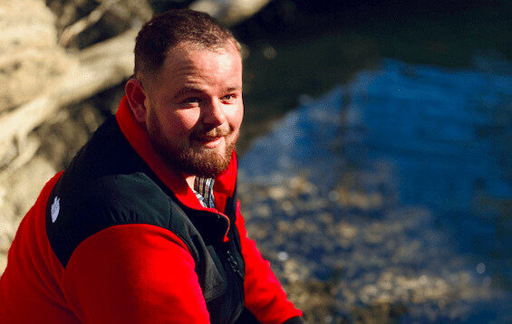 Man smiling near the water